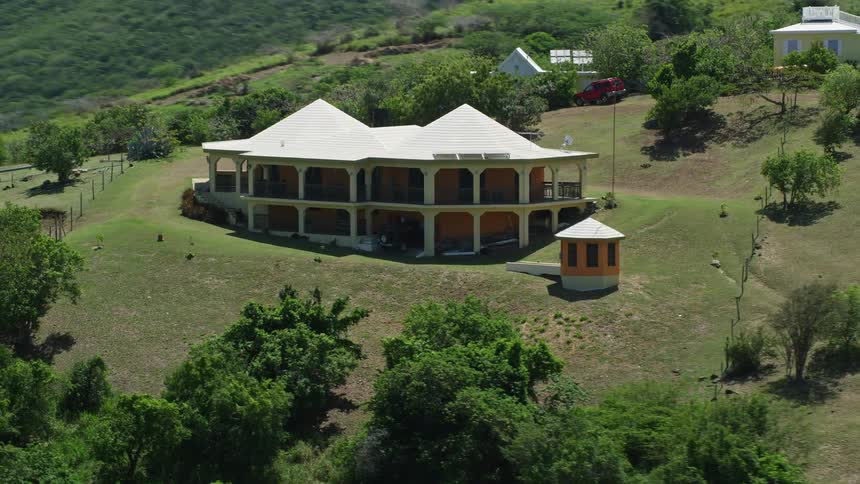 Aerial panorama of a guesthouse nestled in the midst of a mountain