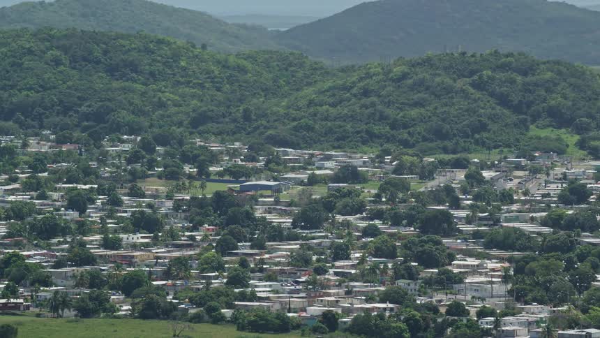 Skyline of a small rural town between meadows and mountains