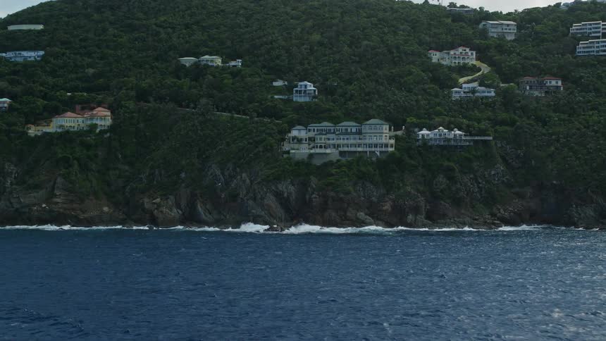 Aerial view of hotels and residential buildings in the mountains next to the sea