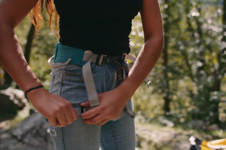 A woman wearing safety equipment in the forest