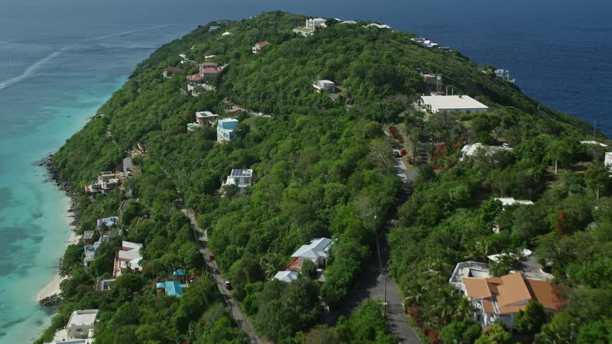 Aerial of a mountainous tropical island with beach houses
