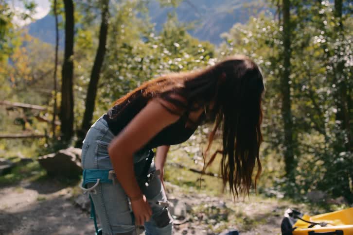 Woman fastening a seatbelt in the middle of a forest