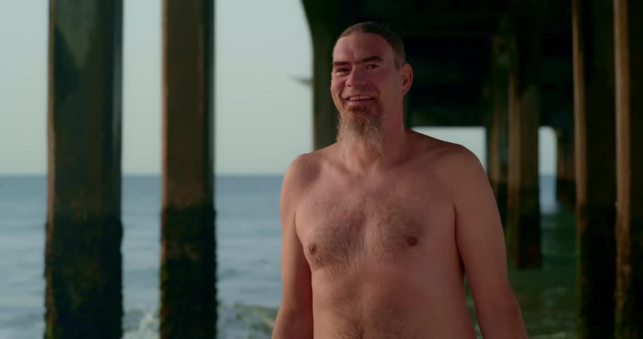 A happy man by the sea during sunset