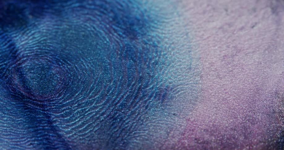 Expanding waves of blue liquid ink