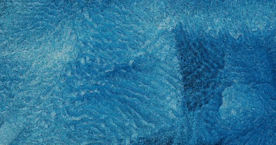 Fluid in watery and shiny blue in slow motion abstract