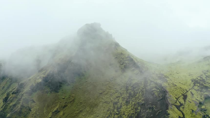 Low lying clouds obscure peak in mountain range