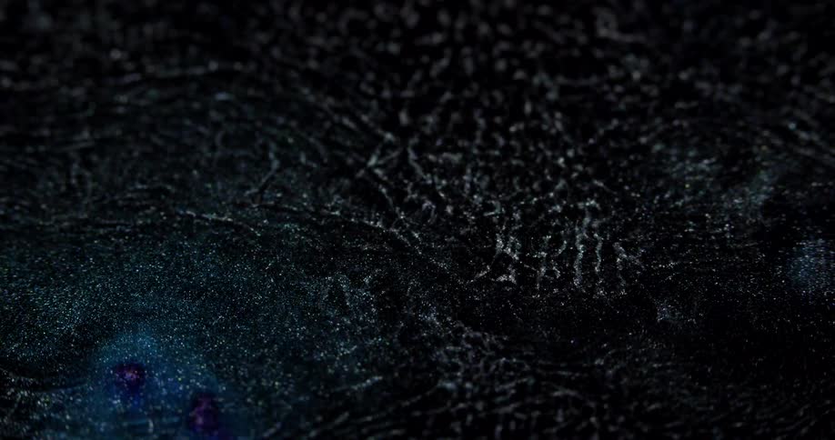 Blue glitter diluting in liquid