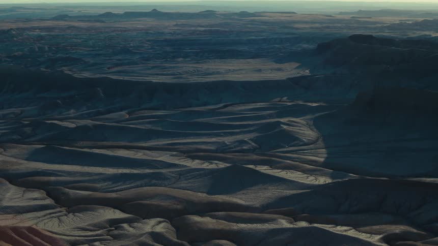 Panoramic view of a landscape with rocky terrain and valleys featuring geological formations