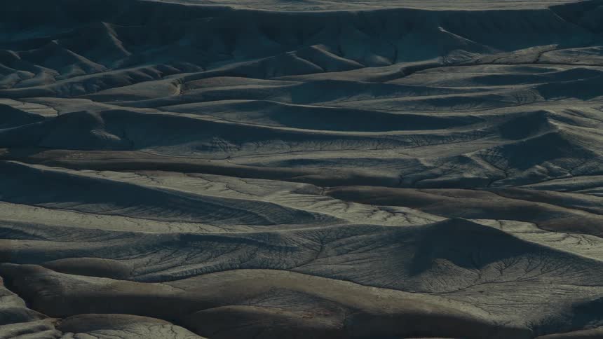 Arid uneven terrain borders plateau