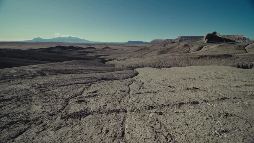 Panoramic view of a rocky terrain with geological mountains on a day with a blue sky