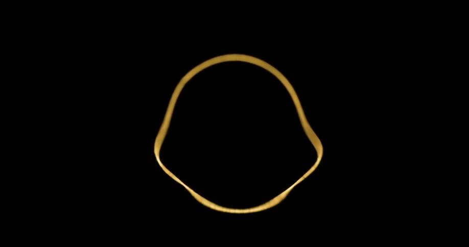 An object with yellow lines is jumping up and down on a black background