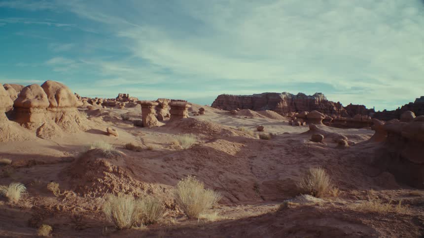 Panorama of a desert terrain with rocks and a valley on the horizon