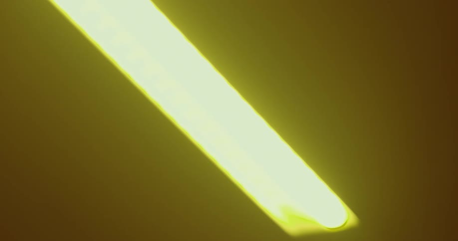 A ceiling of an interior with some yellow lights passing quickly