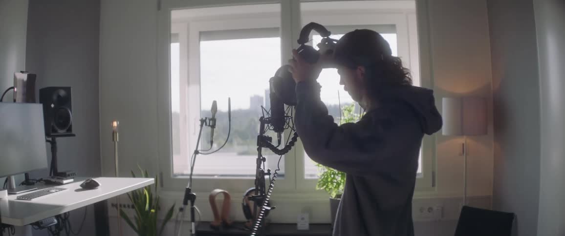 Musician enters his home studio to sing on the microphone