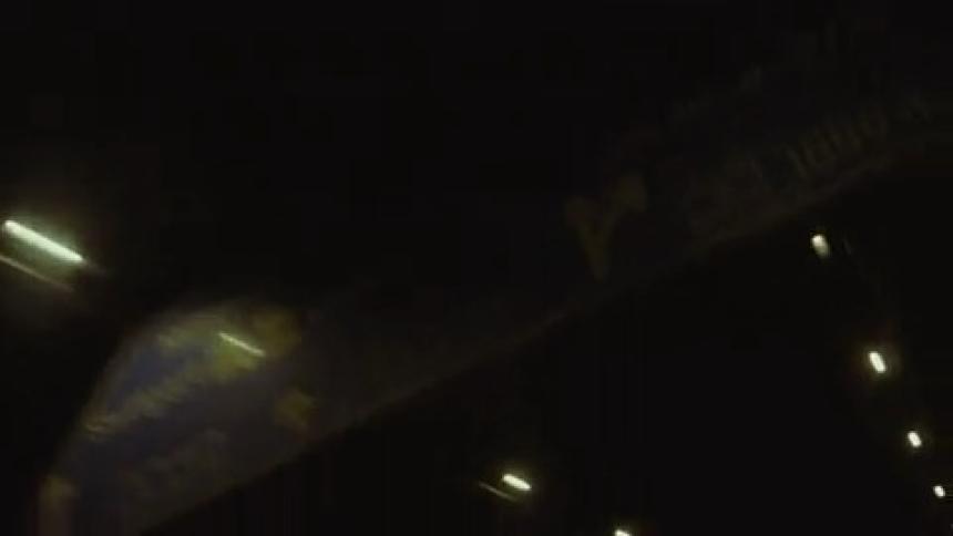 Rows of lights inside a dark tunnel passing overhead