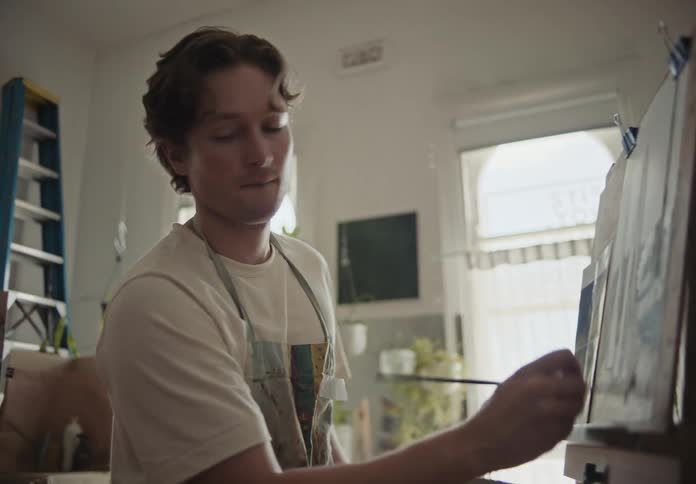 A clip of a painter painting on a board
