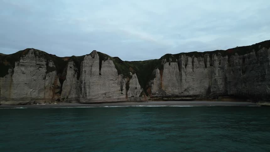 A sea coast with a huge natural stone wall