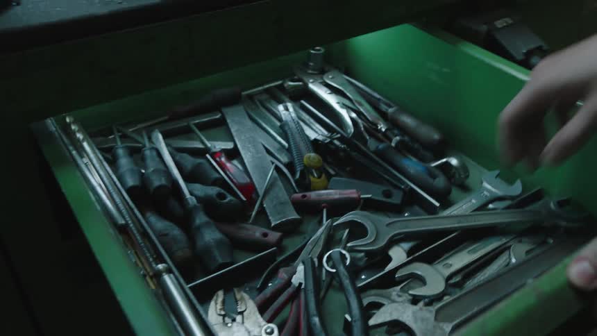 A clip of person taking out tools from the drawls