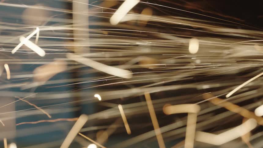 Bright flared sparks coming off a metal machine