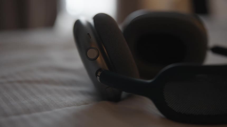 Closeup of wireless headphones on the bed