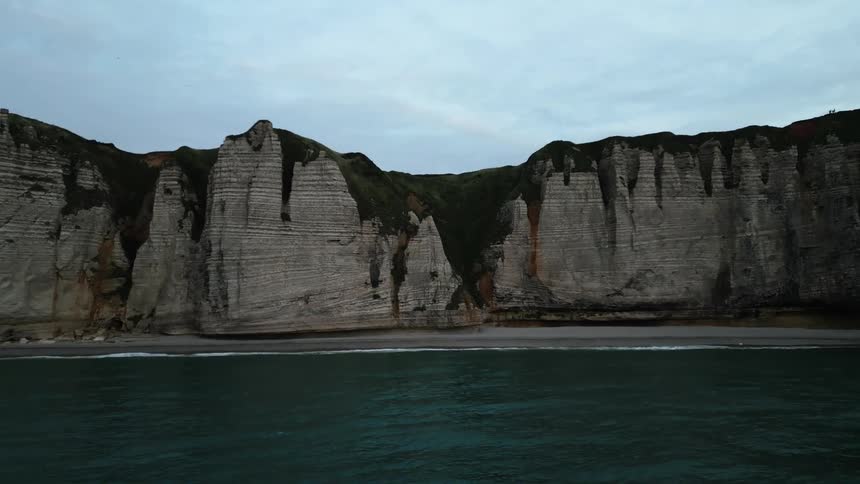 Panoramic view of the blue sea and coastline with rocky mountains on a cloudy day