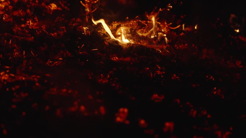 Flames consume pieces of wood