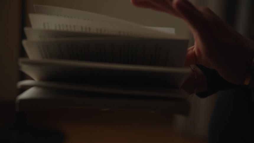 Closeup of a hand turning the pages of a book