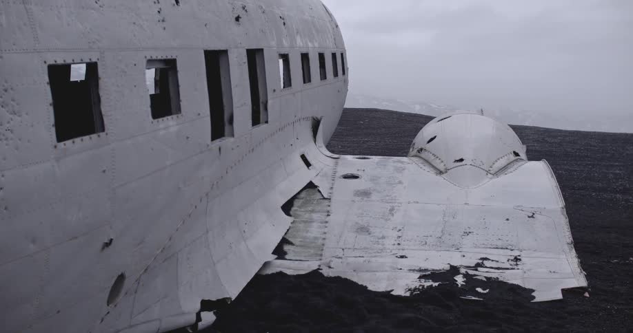 The downed plane has no windows and a broken wing