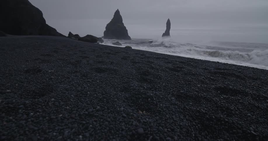 Waves washing up on a rocky beach on cloudy evening