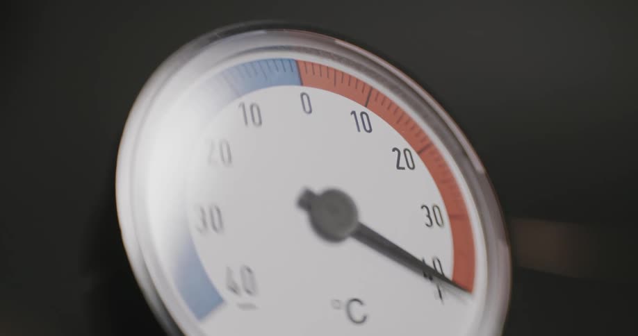 The dial on a thermometer rises quickly