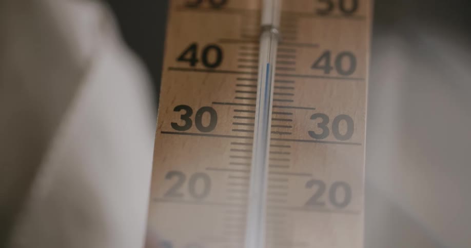 A wall thermometer showing temperature rapidly rising