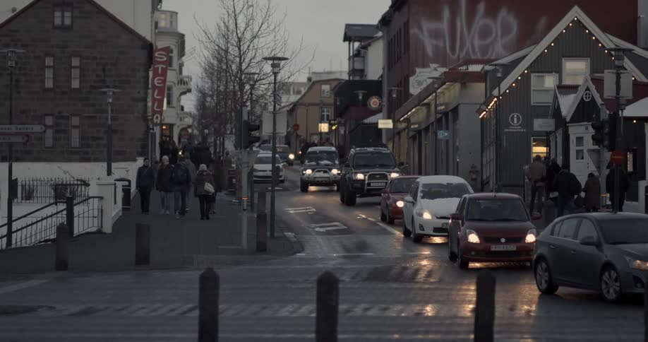 A line of cars on a brick road