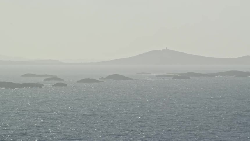 Aerial of small islets in the sea during cloudy day