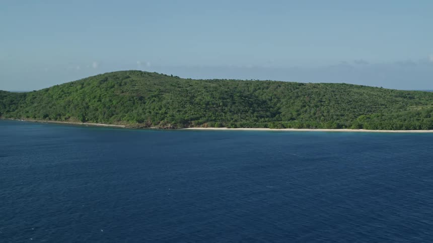 A beach near the ocean on a mountain island