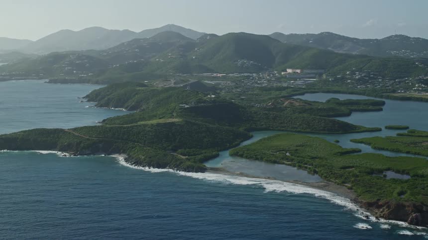 Aerial panorama of an archipelago with the blue sea mountain ranges and buildings on the hills