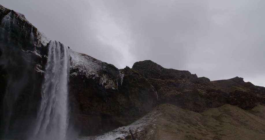 Clouds and gray skies over a waterfall