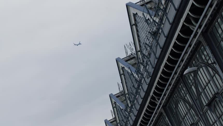 A clip of a plane flying above a bridge