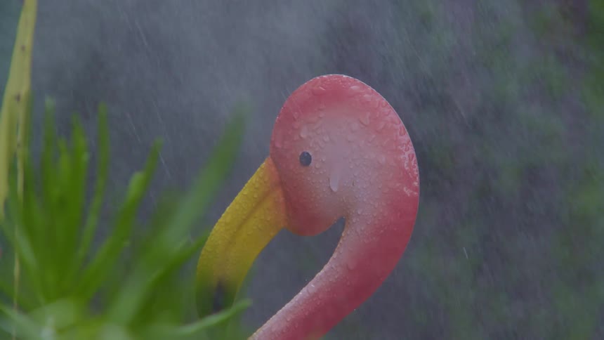 A flamingo sculpture in a garden