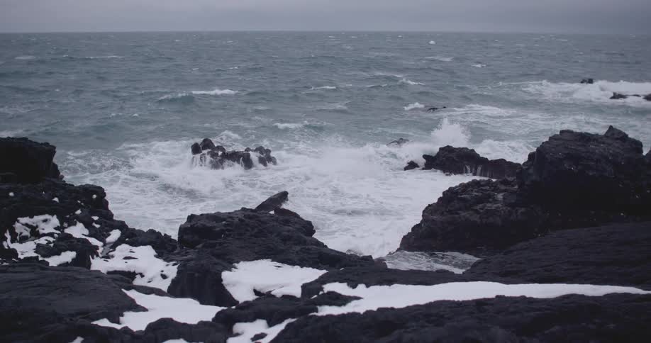 Waves crash into the rocky shoreline