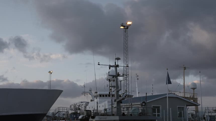 A shoreside building is shown on a cloudy day