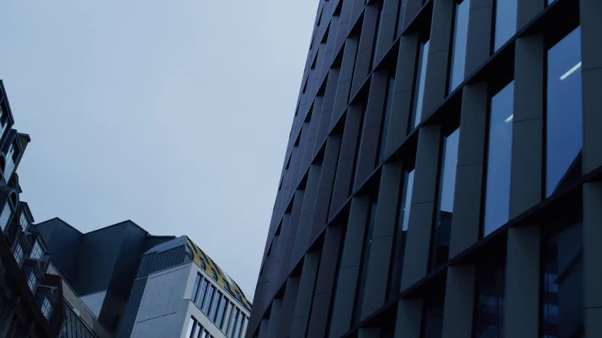 A building with glass windows in a city