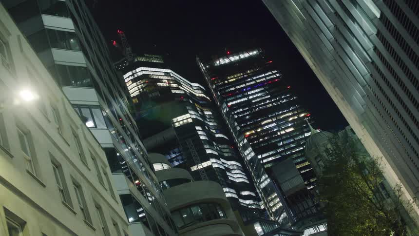 The buildings are brightly lit at night