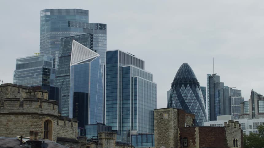 Architecture of a castle with huge modern buildings right behind it in a metropolis