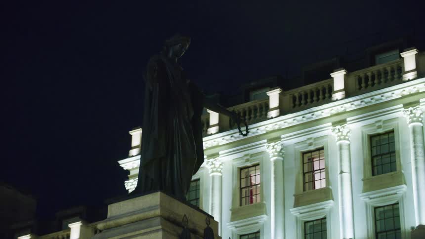 Bronze statues in a residential neighborhood at night