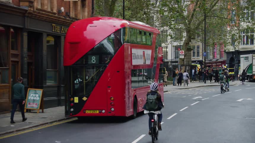 A bicyclist rides through a city