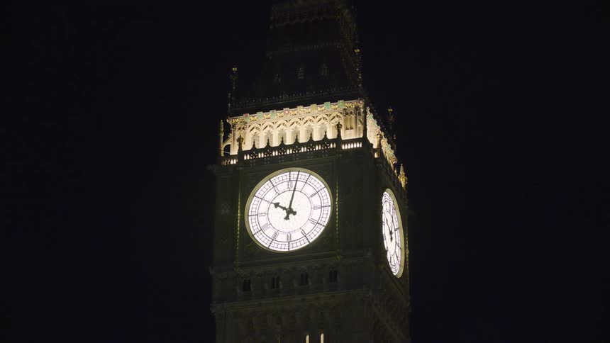 The clock tower is lit at night