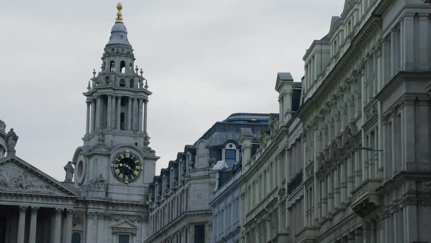 Skyline of a clock tower with classical architecture during a cloudy day