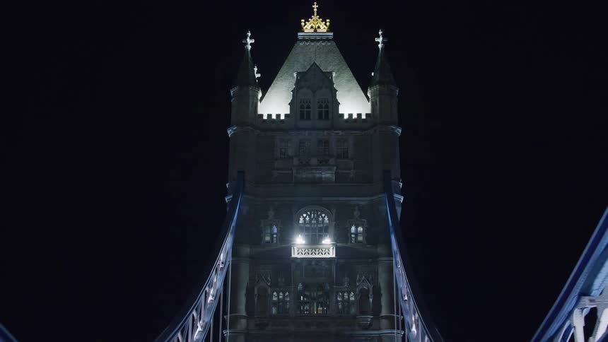 London bridge arches with purple lights glowing at night