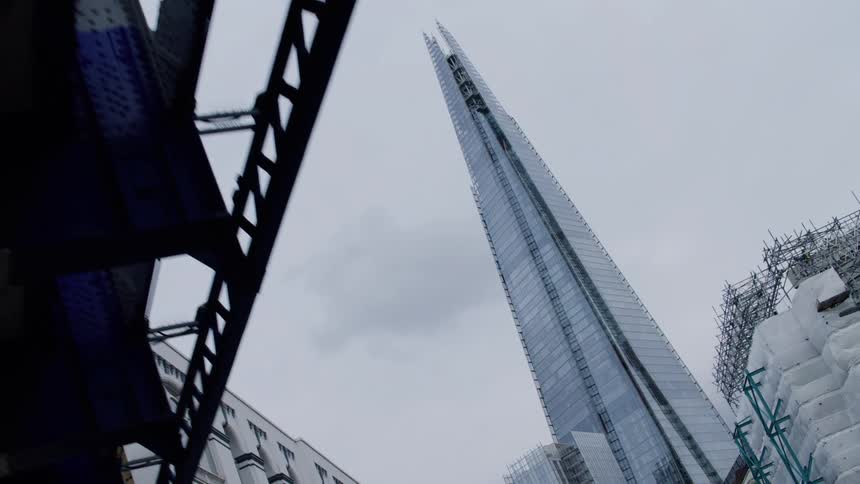 A tall skyscraper is past the overpass