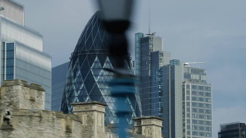 Large buildings with modern architecture all mirrored in glass during the day